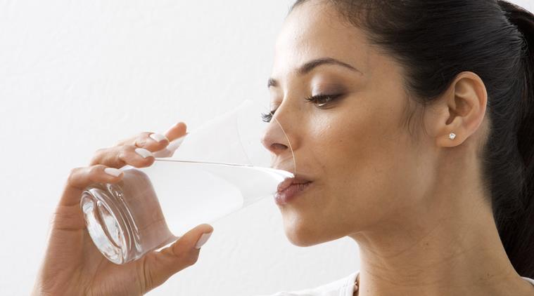 Close-up of a young woman drinking water